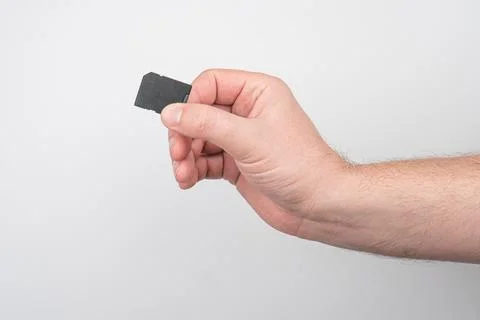 Close up SD memory card in fingers Stock Photos