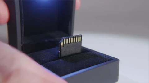 Close up of an SD memory card inside a luxury matte black box Stock Footage 334543722