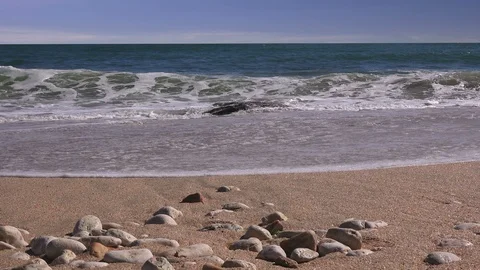 Close up of sea pebbles against the backdrop of a stormy sea Stock Footage 101838771