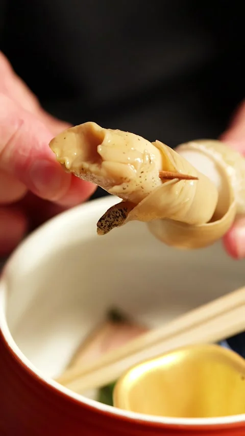 Close Up of Sea Snail Meat Being Extracted from Shell Stock Footage 337876683