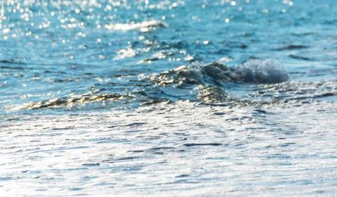 Close up of the sea water affecting the sand on the beach, sea waves calmly Stock Photos