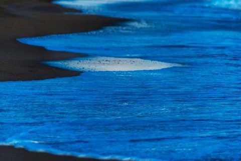 Close up of the sea water affecting the sand on the beach, sea waves calmly Stock Photos