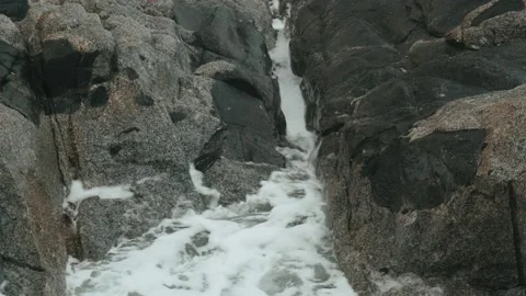 Close-up of sea waves breaking on rocks. White sea foam bubbles on the surface Stock Footage 178400526