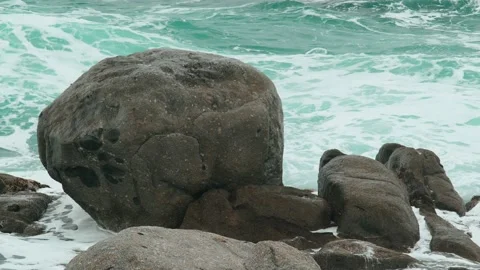 Close-up of sea waves breaking on rocks. White sea foam bubbles on the surface Stock Footage 178956293