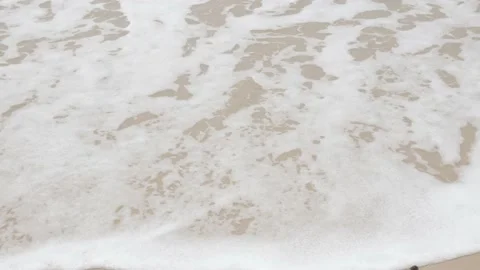 Close up to Sea waves rolling over the fine sand beach, waves break on white  Stock Footage 220000852