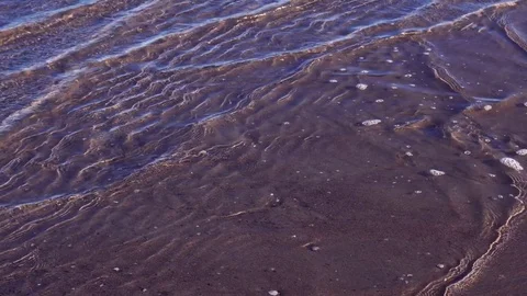 Close up sea waves on a sandy beach. Sandy bottom under transparent ocean water Stock Footage 82890993