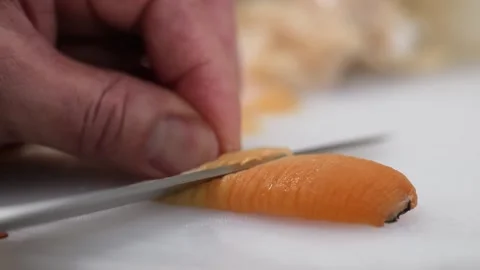 Close-Up of Seafood Chef Thinly Slicing Giant Geoduck Siphon for Sashimi Видео 344230207