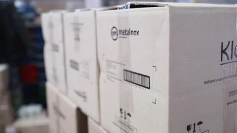 Close-up of sealed cardboard shipping boxes featuring the Metalnox Stock Footage 326032394
