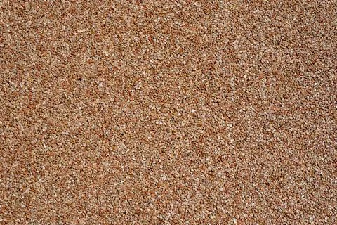 Close-up of a seamless exposed aggregate surface with warm terracotta and bro Stock Photos