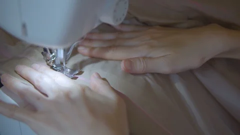 Close up of seamstress hands using sewing machine Stock Footage 110457352