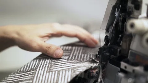 Close up of a seamstress making an even cloth edge on a sewing machine 스톡 동영상 80786345