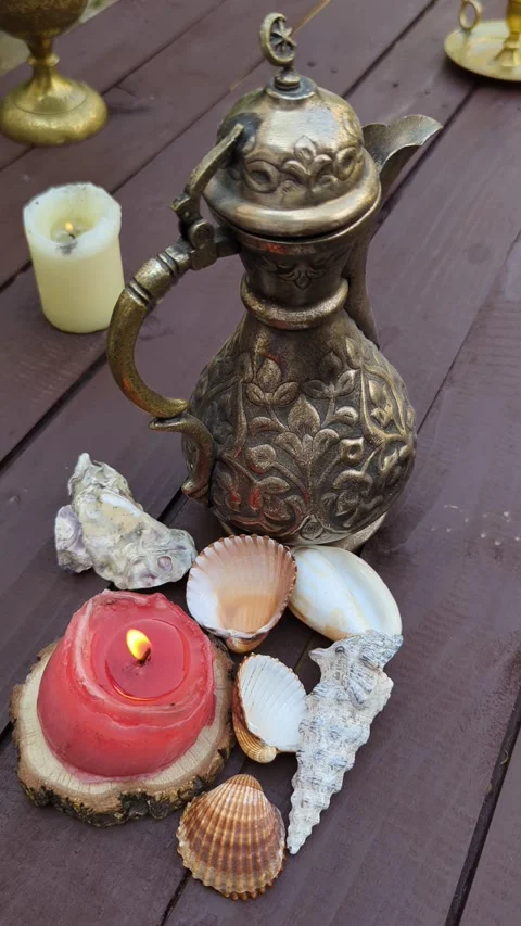 Close up of seashells and two burning candles Ottoman jug Stock Footage 342845467