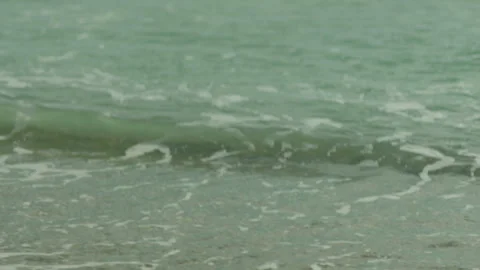 Close-up of the seashore. Calm waves of ocean water lapping the sandy beach. Stock-Footage 241312296