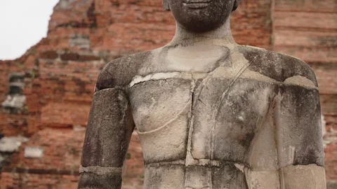 Close up of seated Buddha stone statue in lotus position at Wat Mahathat ruins Stock Footage 312429641