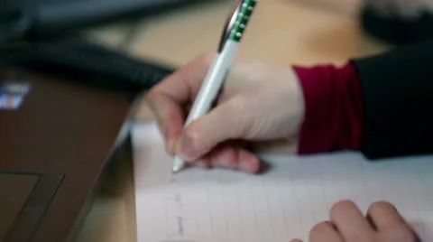 Close up on secretary writing on documents and typing on PC Stock Footage 27876925