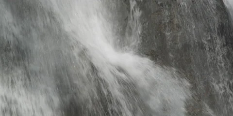 Close-up section of waterfall veiling the rocky cliff face behind it Stock Footage 59528437