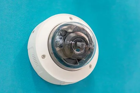 Close-up security camera in controlled lighting environment, white glossy d.. Photos