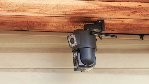 A close-up security camera monitors the area around the house Stock Footage 320987472