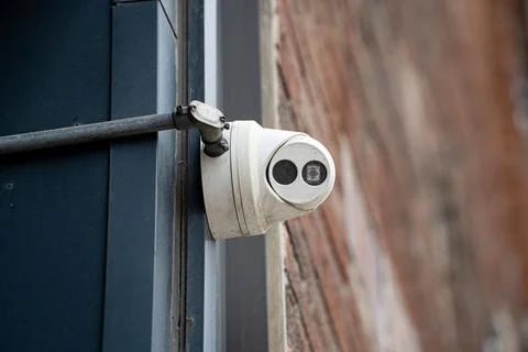 Close up of security camera mounted on exterior wall of building Stock Photos