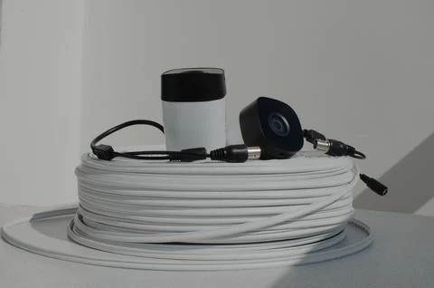 Close-up of a security camera with a roll of wire, showing care for securit.. 库存照片