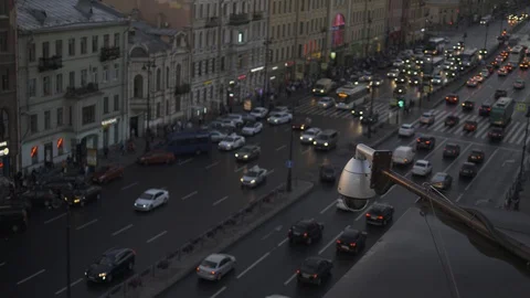 Close up Security CCTV camera operating over the road at dusk. Big traffic on Stock Footage 94728024