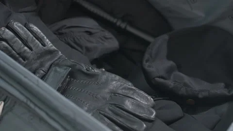 Close up of security gear in box with hand unpacking gloves and hat Stock Footage 308658959