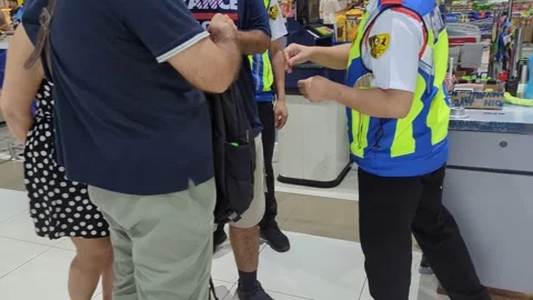 Close up of a Security Officer Checking a Man's Backpack at a Store Entrance Stock Footage 328906781