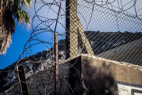 Close-up of security razor wire and barbed wire fence at historic military .. Stock Photos