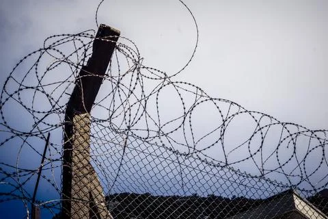Close-up of security razor wire and barbed wire fence at historic military .. Stock Photos
