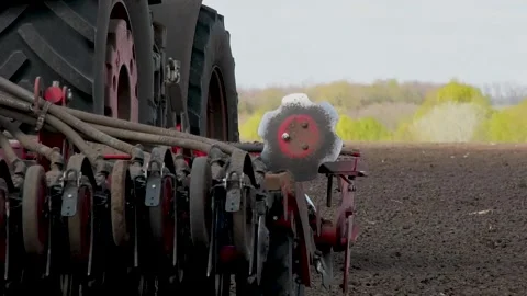 Close-up of a seeder working in a field during spring sowing of wheat and grain Stock Footage 348268301