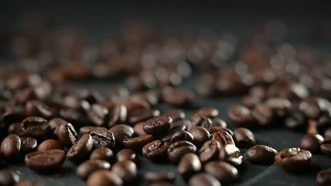 Close up of seeds of coffee. Coffee beans are scattered on the table. Stock Footage 154806654