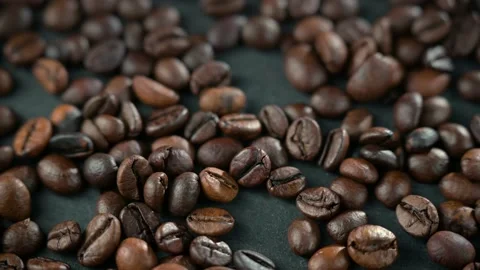 Close up of seeds of coffee. Coffee beans are scattered on the table. Stock Footage 154806676