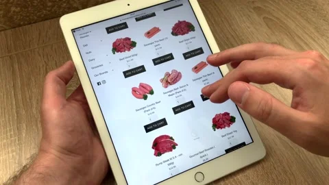 Close-up selection of fresh meat and sausages in an online store using a tablet Stock Footage 133708386