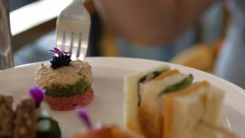 Close up selective focus to canape sandwich in white plate while using silv.. Stock Footage 276353165