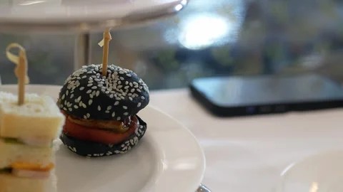 Close up selective focus to canape sandwich in white plate while using hand.. Stock Footage 277353877