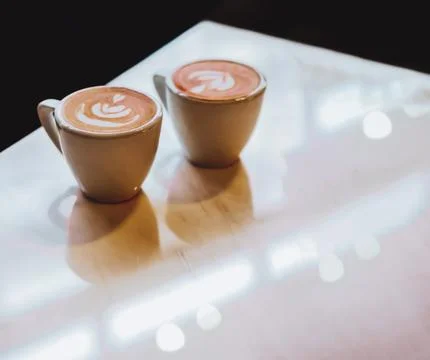Close up selective focus coffee cup with latte art on dark background with .. Stock Photos