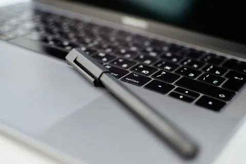 Close-up selective focus computer laptop keyboard and pen Stock Photos