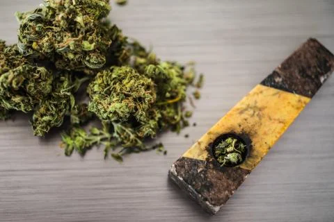 Close up selective focus on marijuana and pipe background Stock Photos