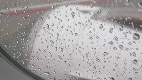 Close up selective focus of rain drops on the window surface of the plane i.. Stock Footage 312350108