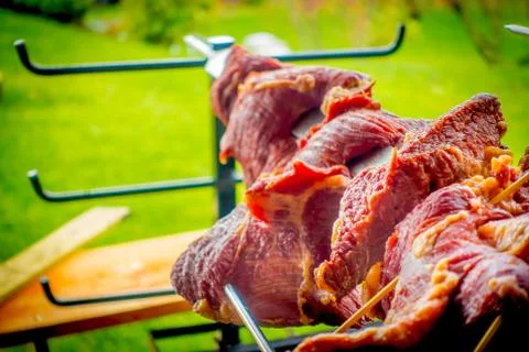 Close up of selective focus of raw meatn skewers in a blurred backyard Stock Photos