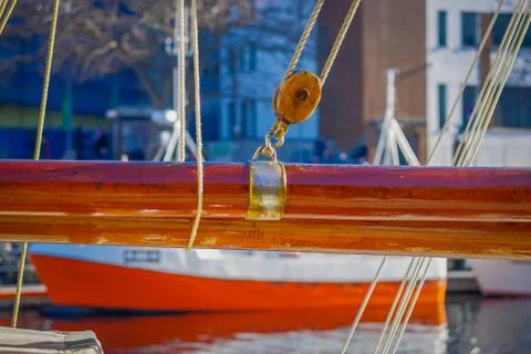 Close up of selective focus of ropes around mast support boom on boat in port of Фото