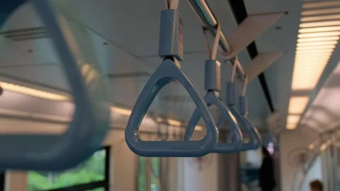 Close-up selective focus shot of blue plastic grab handles hanging from the.. Stock Footage 348284568