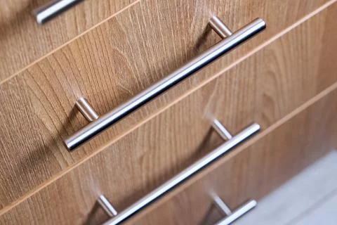 Close-up selective focus shot features rectangle-shaped kitchen cabinet drawe Stock Photos