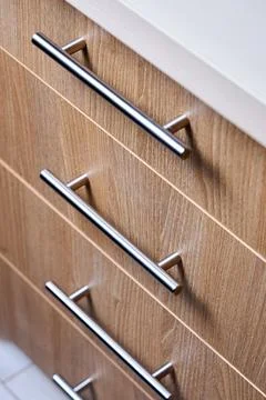 Close-up selective focus shot features rectangle-shaped kitchen cabinet drawe Stock Photos