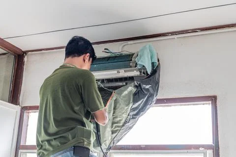 Close up, Selective focus. The technician is installing the air conditioner.. Stock Photos