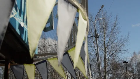 Close-up, selective focus, wind slaps garlands of colorful flags against blue 스톡 동영상 88040136