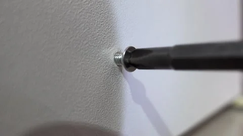 Close up of a self-tapping screw fastened into a plywood board Stock Footage 326063813