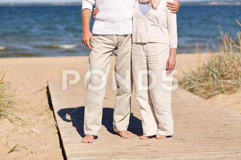 Close up of senior couple hugging on summer beach Stock Photos
