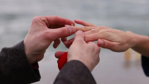 Close-up senior female hand getting engagment ring on her finger from elderly Stock Footage 102883129