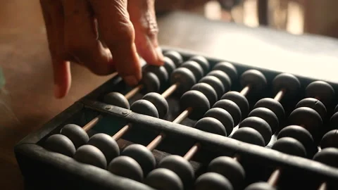 Close up of senior hand using chinese abacus or old antique calculator on table Stock Footage 138079036